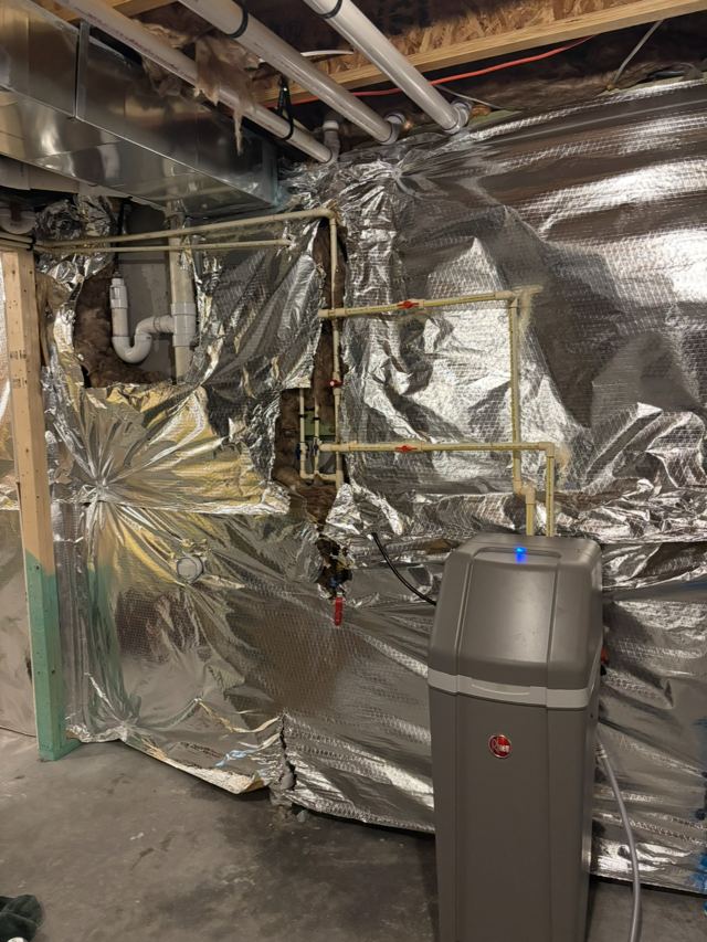 Water softener installed in a basement and tied into the supply lines